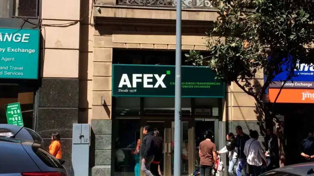 Fachada da casa de câmbio Afex em Santiago, Chile, com placa verde e destaque para serviços de câmbio e transferências.